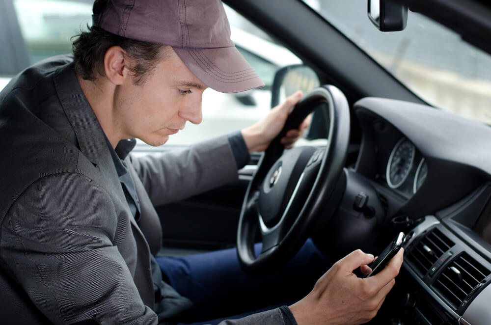 Distracted driving is a common cause of parking lot accidents.